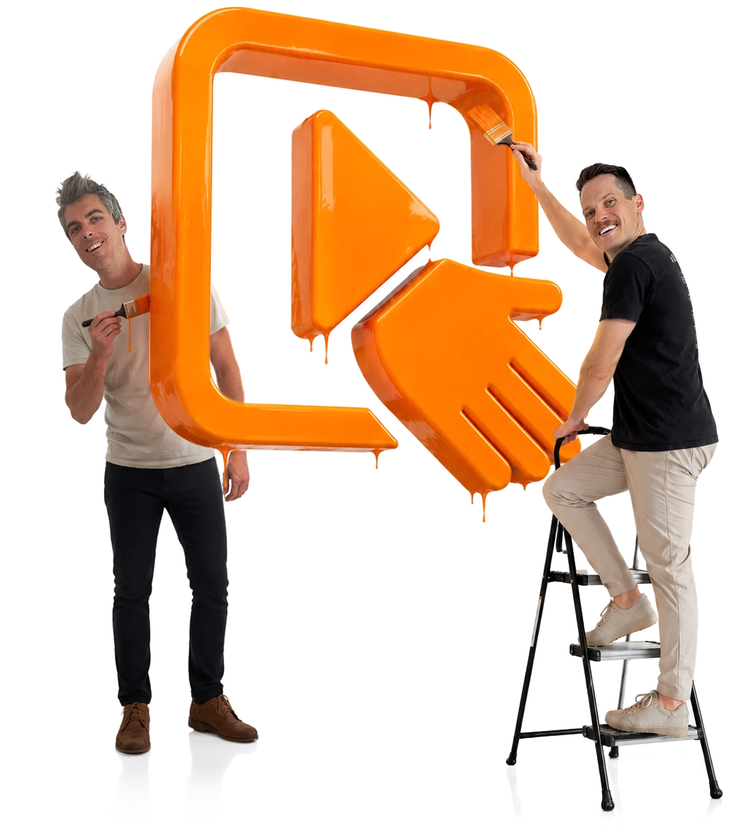The two Handshake founders painting the studio logo